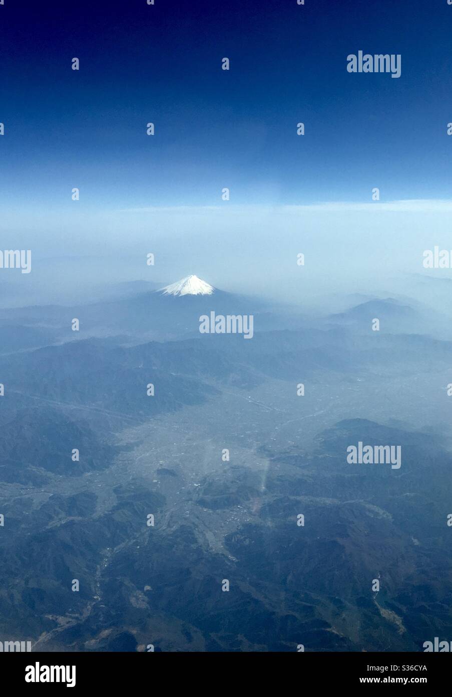 Mount Fuji, in Japan, partially covered in snow in the spring time. - Smartphone Captured Stock Image