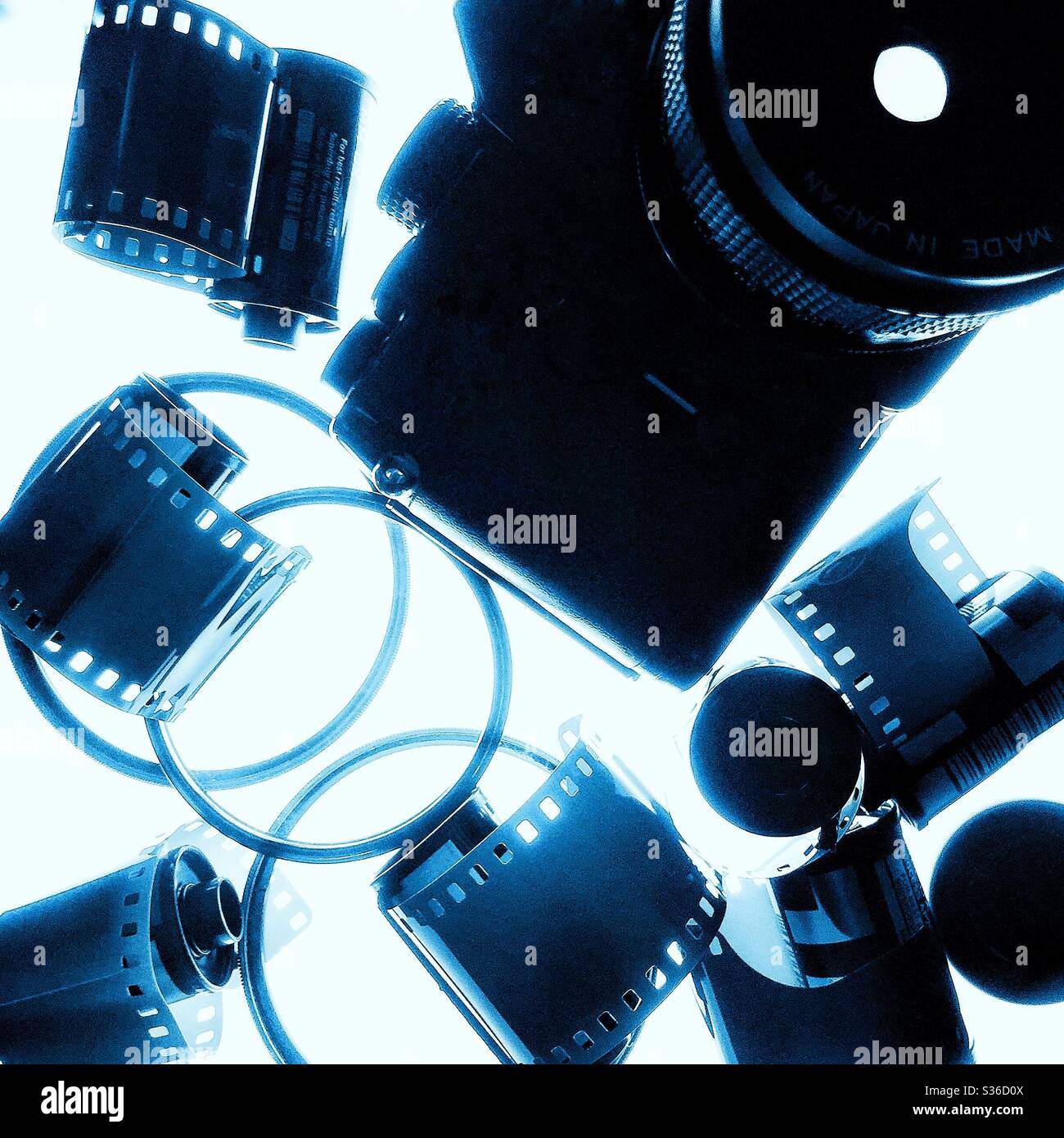 Analogue film camera and film cassettes. - Smartphone Captured Stock Image