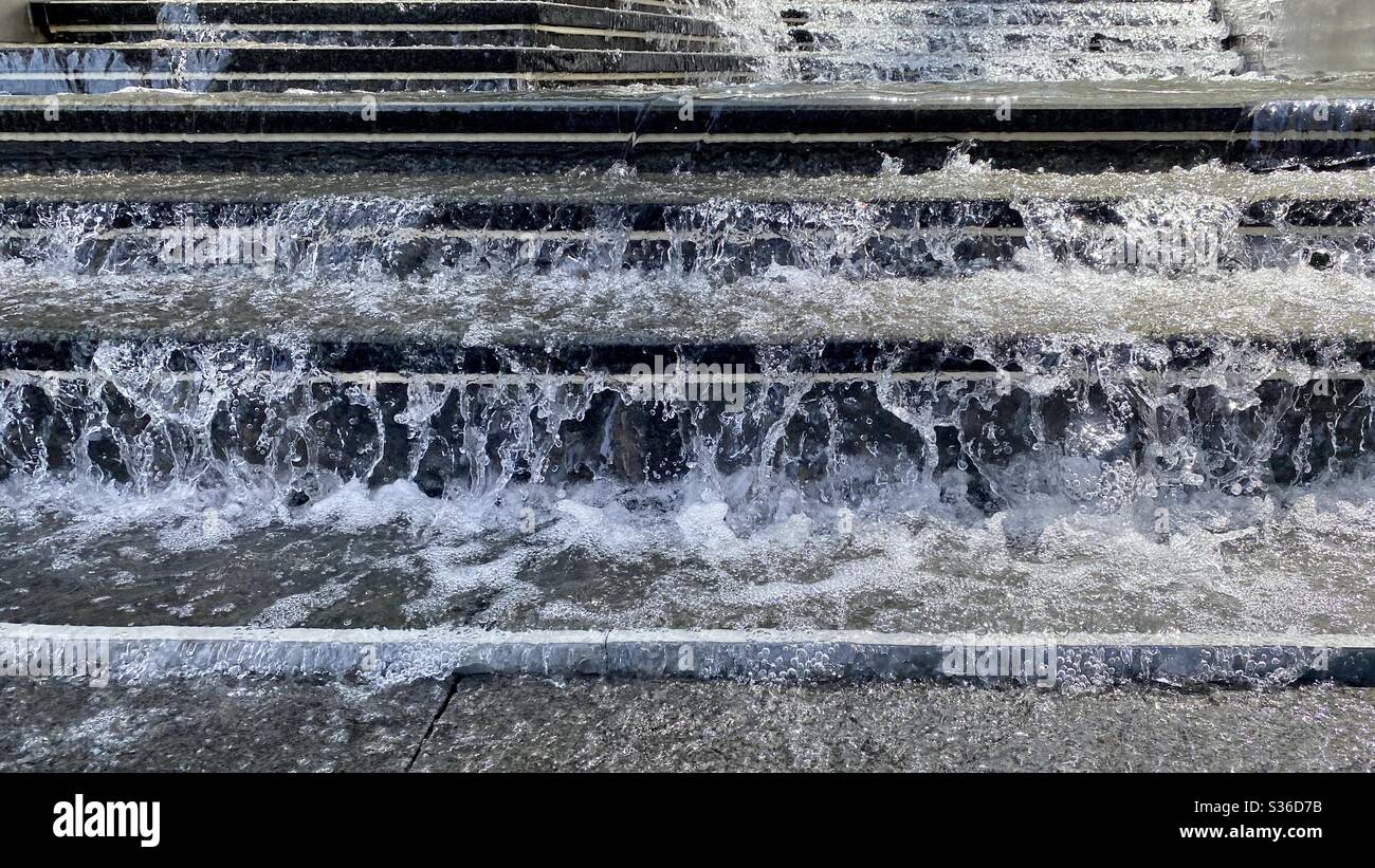 Detail of water splashing and falling down dark marble steps in daylight - Smartphone Captured Stock Image Detail of water splashing and falling down dark marble steps in daylight - Smartphone Captured Stock Image