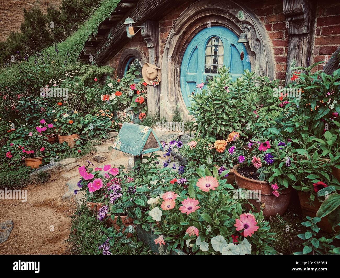 Hobbiton. Bucolic place in New Zealand where the hobbits from the Middle Earth live. Lord of the rings movie set. Blue round shape door Stock Photo