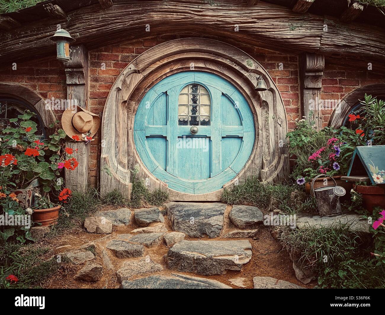 Hobbiton. Bucolic place in New Zealand where the hobbits from the Middle Earth live. Lord of the rings movie set. Blue round shape door Stock Photo
