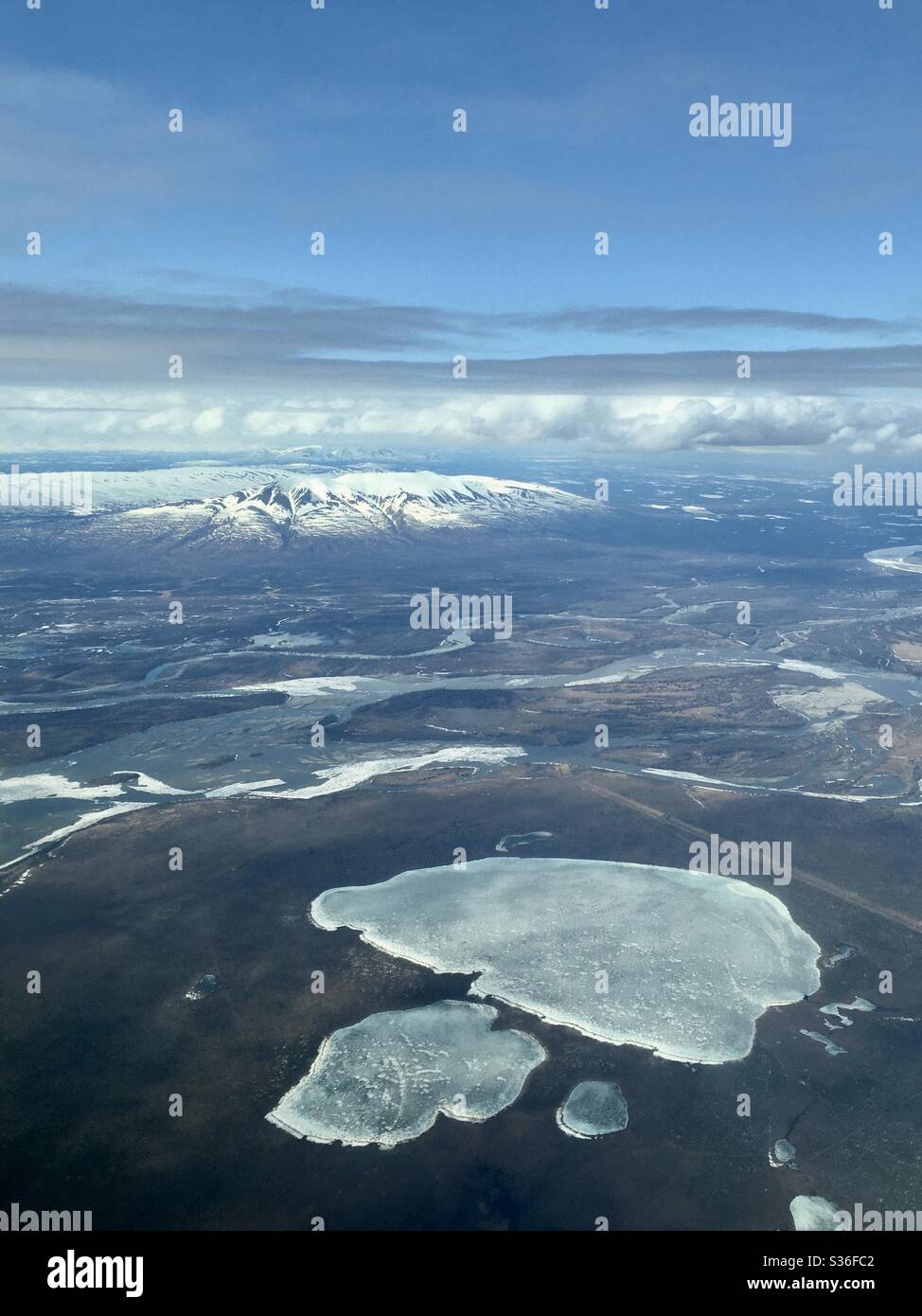 Aerial image of wild areas to the west of Anchorage, Alaska, with the ‘Sleeping Lady’ mountains in the distance. Stock Photo
