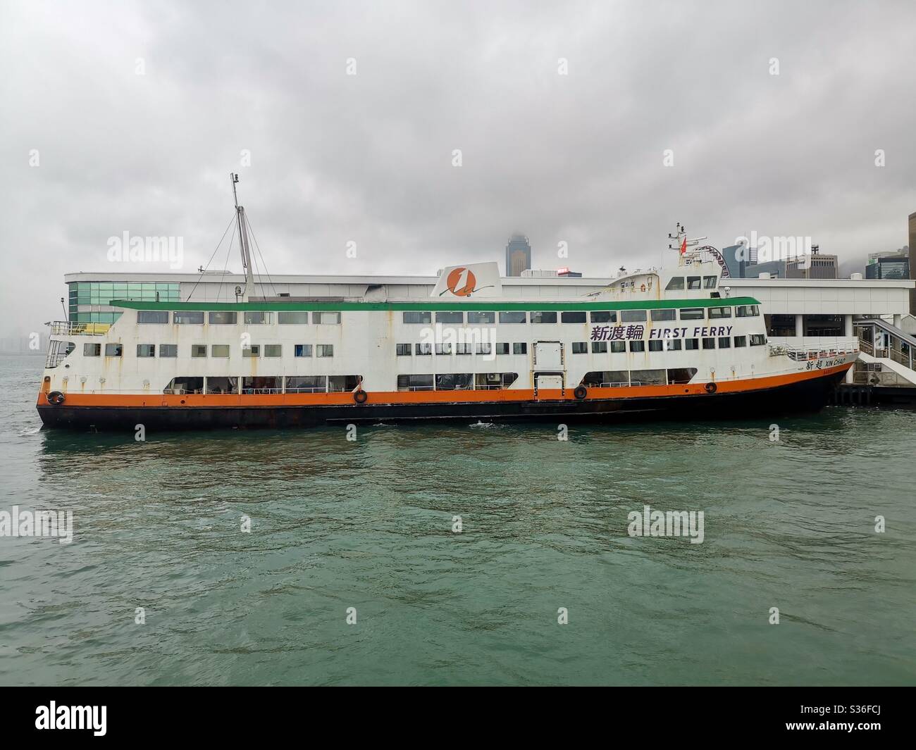 A ‘First ferry’ boat docking at the central piers in Hong Kong. - Smartphone Captured Stock Image
