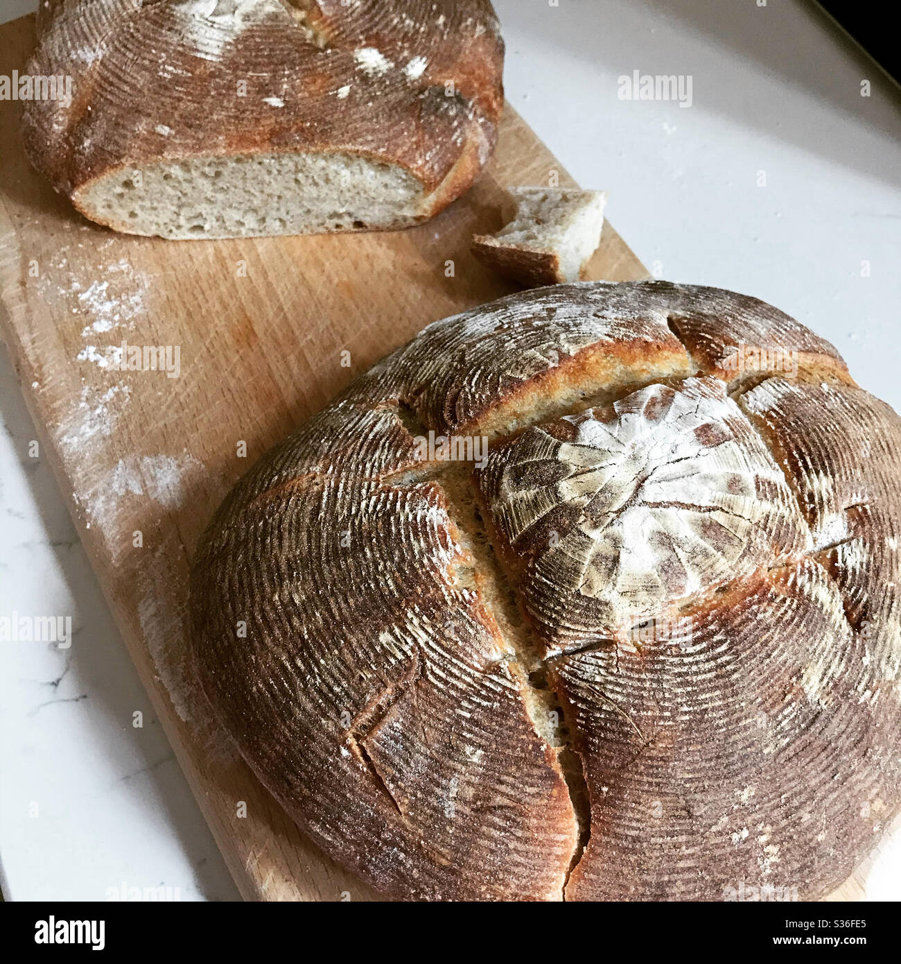 Sourdough loaves in a wooden board Stock Photo