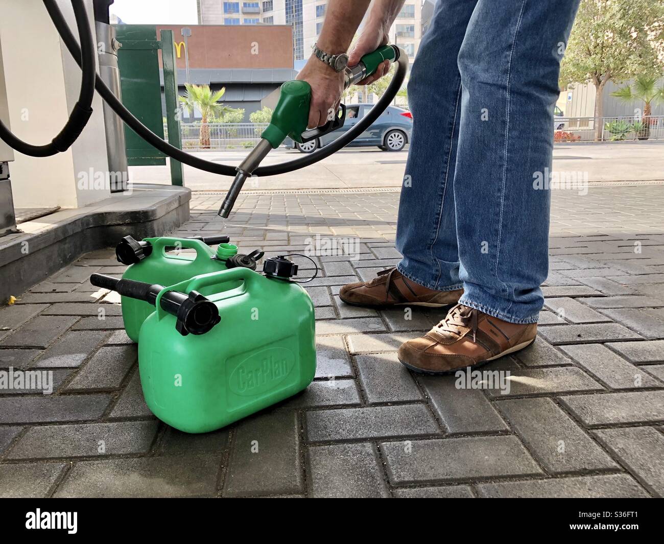 Filling up fuel cans at a petrol station Stock Photo