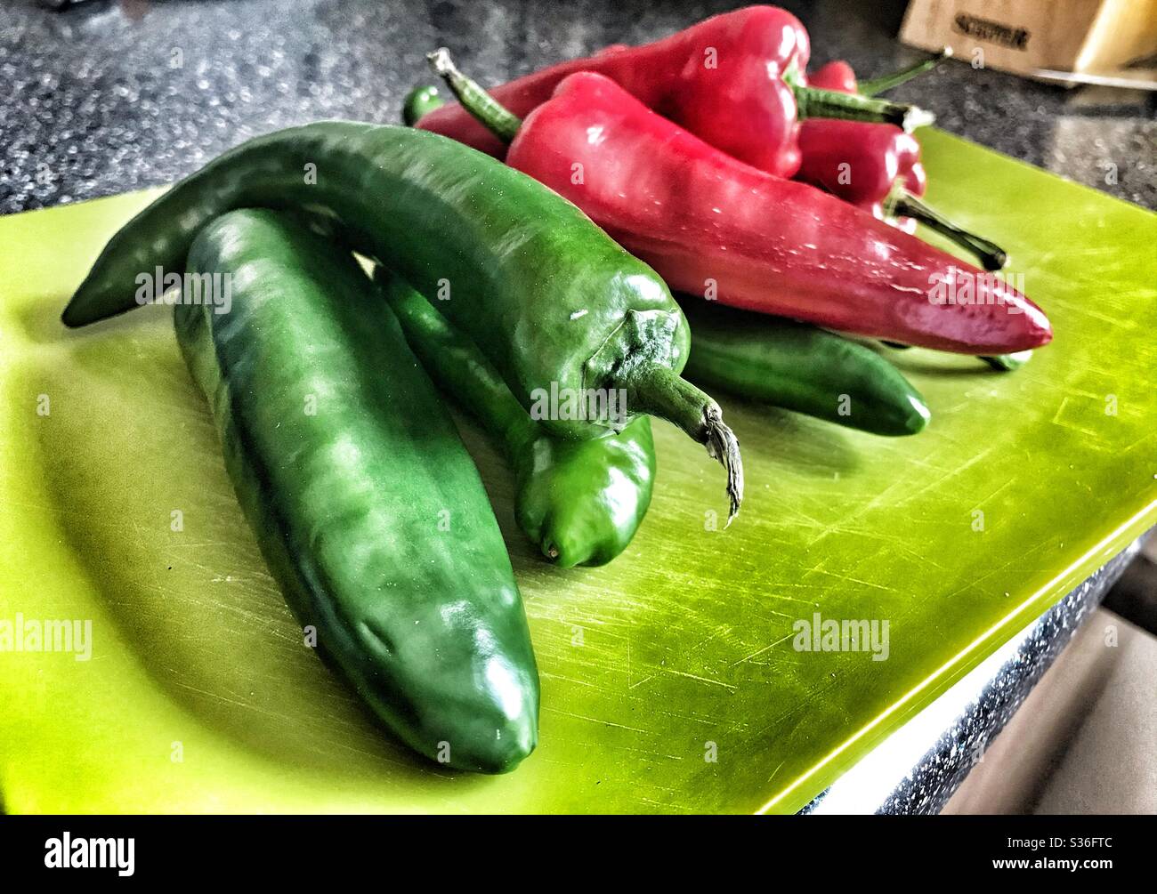Green Chopping Board With Red and Green Chillis on it Stock Photo