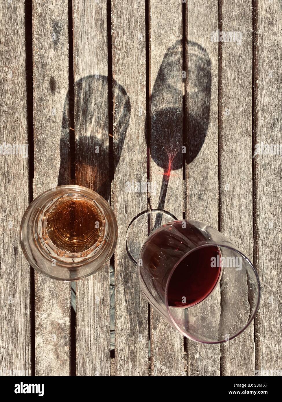 Glasses with shadows on wooden table - Smartphone Captured Stock Image
