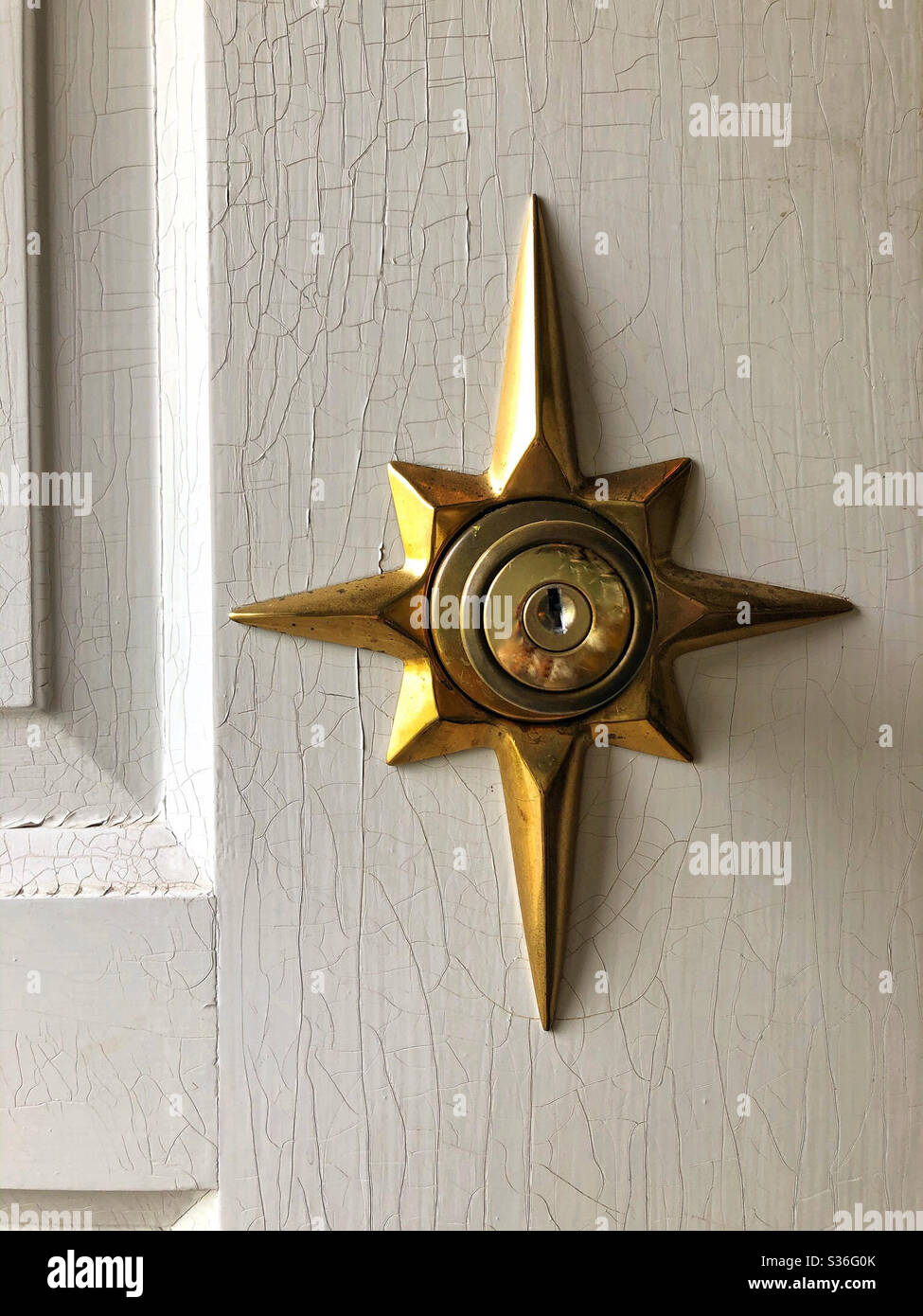 Vintage star shape keyhole detail on front door of house - Smartphone Captured Stock Image