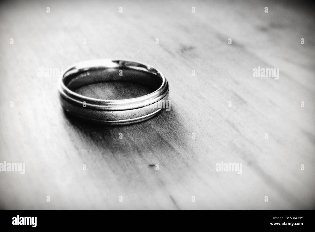 Close Up of Man's Wedding Ring in Black and White Stock Photo