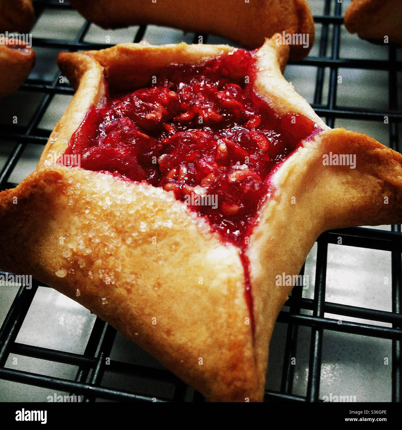 Close up of Raspberry Filled Hamantaschen on Cooling Rack Stock Photo