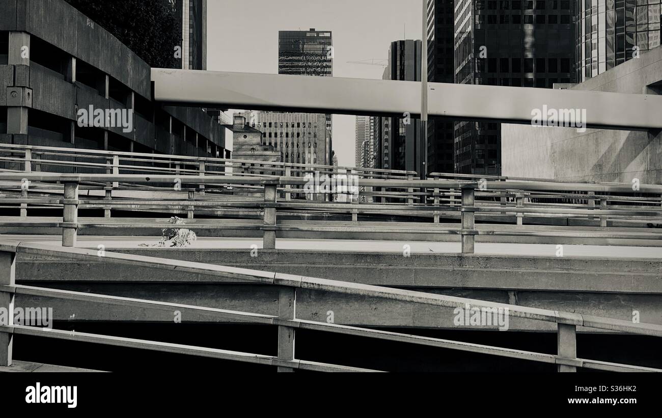 LOS ANGELES, CA, MAY 2020: cross-crossing roads and pedestrian bridges over Flower St in Downtown. Black and white cityscape - Smartphone Captured Stock Image