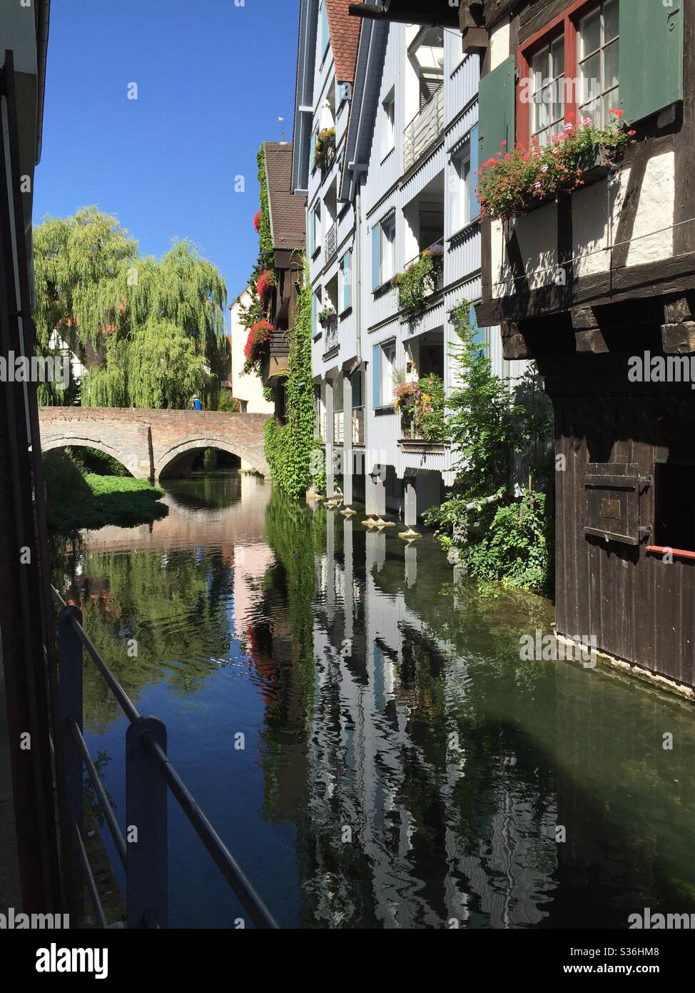 Houses reflected in stream Stock Photo
