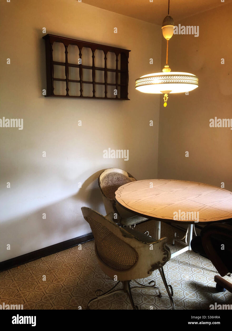 Empty kitchen table at vacant home with air of melancholy - Smartphone Captured Stock Image