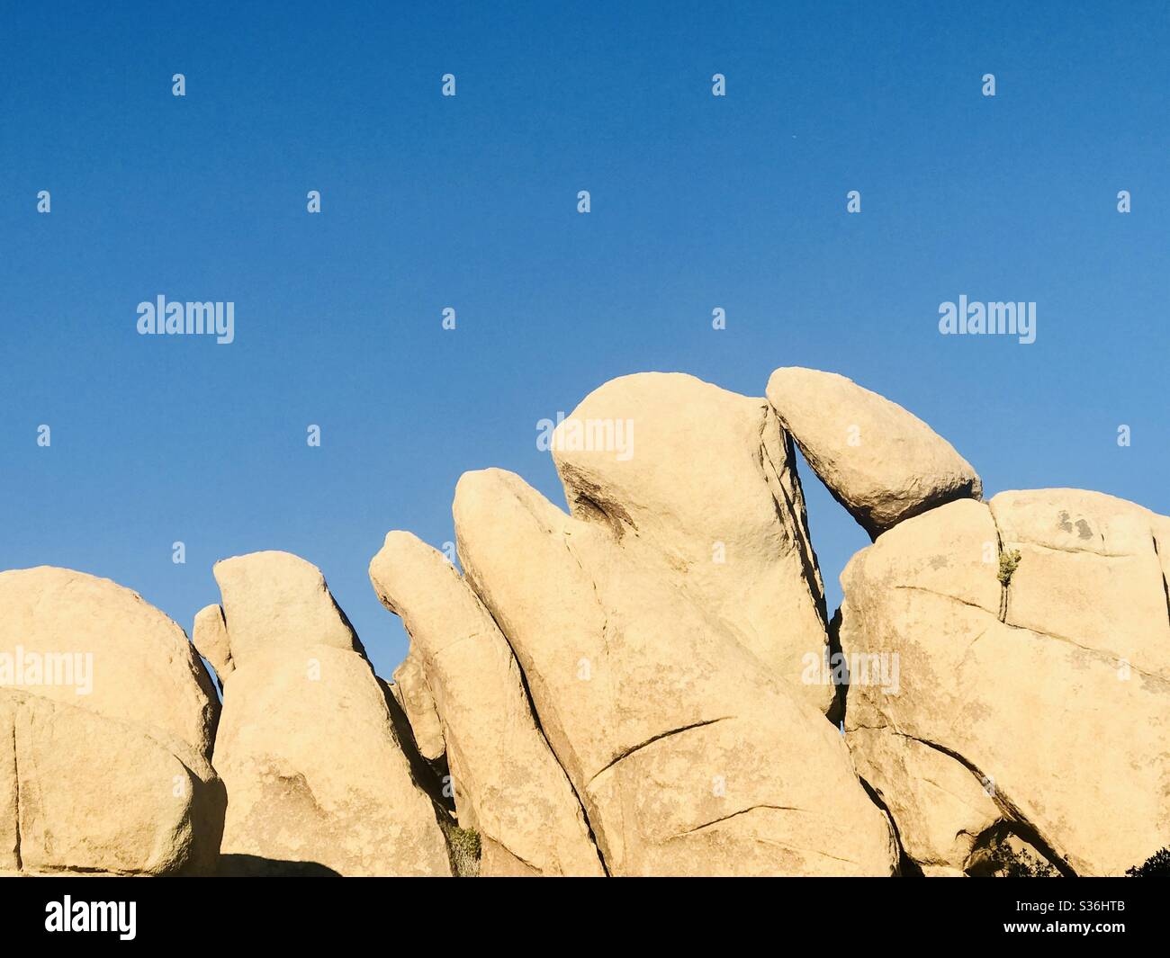 A line of unique shapes rock formations in Joshua Tree National Park. Stock Photo