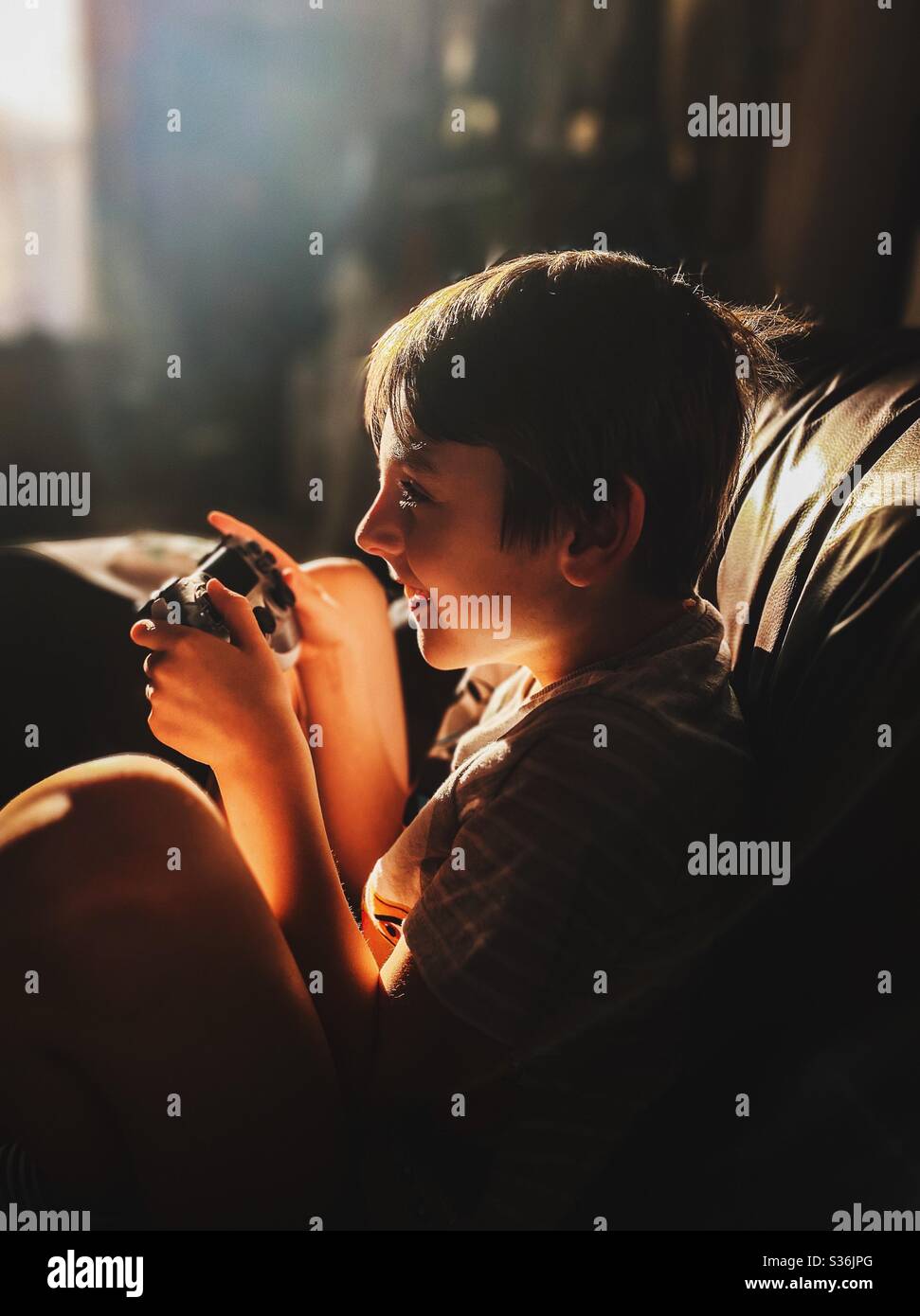 Boy playing games console Stock Photo