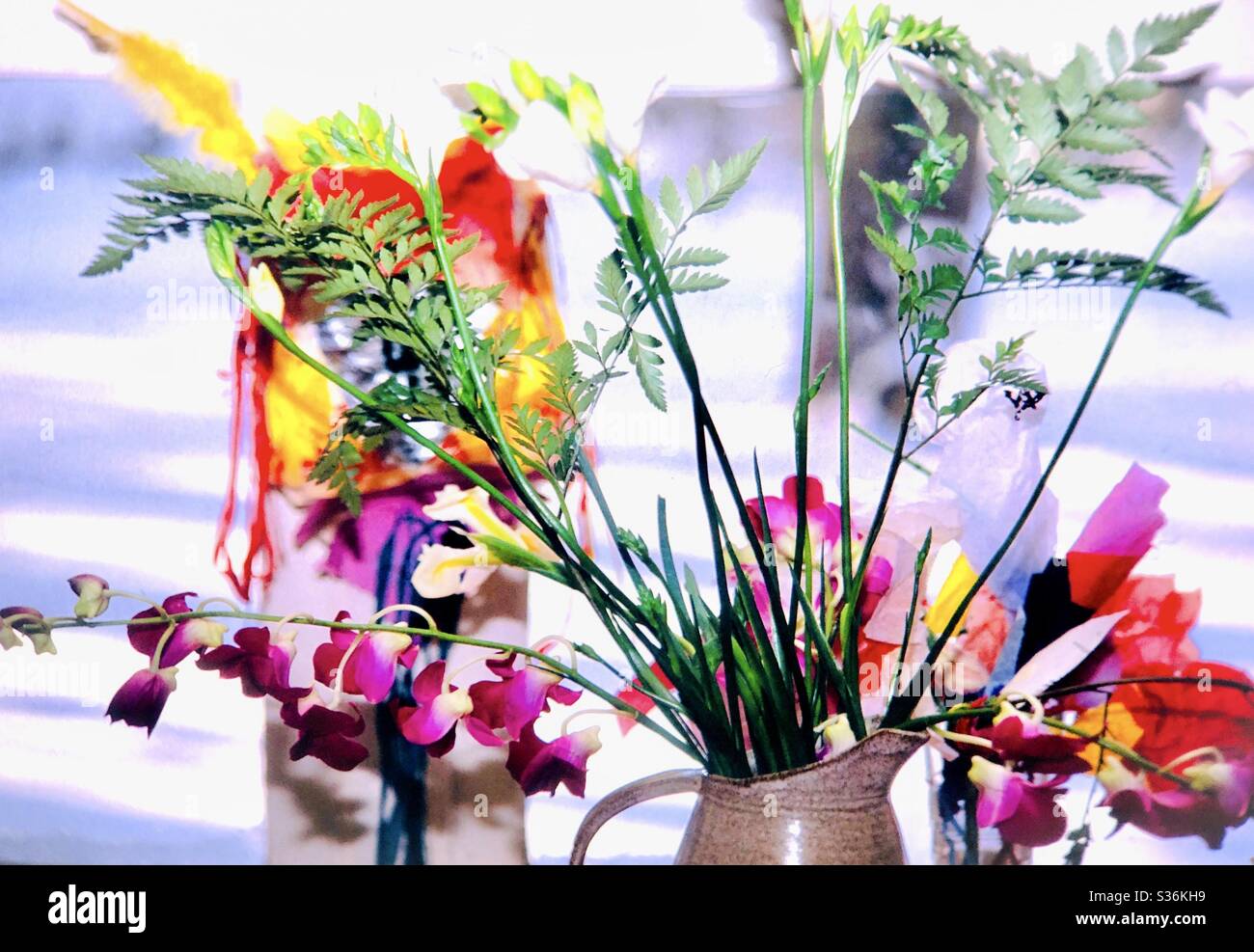 Mixed flowers arrangement on windowsill Vibrant colors casual display Stock Photo