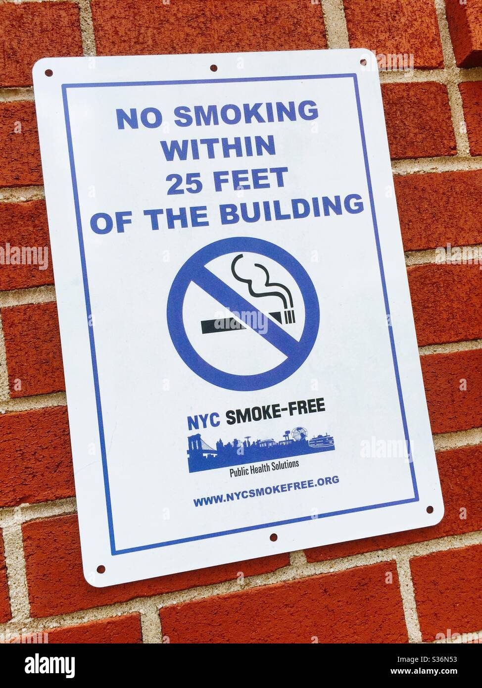 NYC smoke-free sign plastered on a brick wall, New York City, USA - Smartphone Captured Stock Image