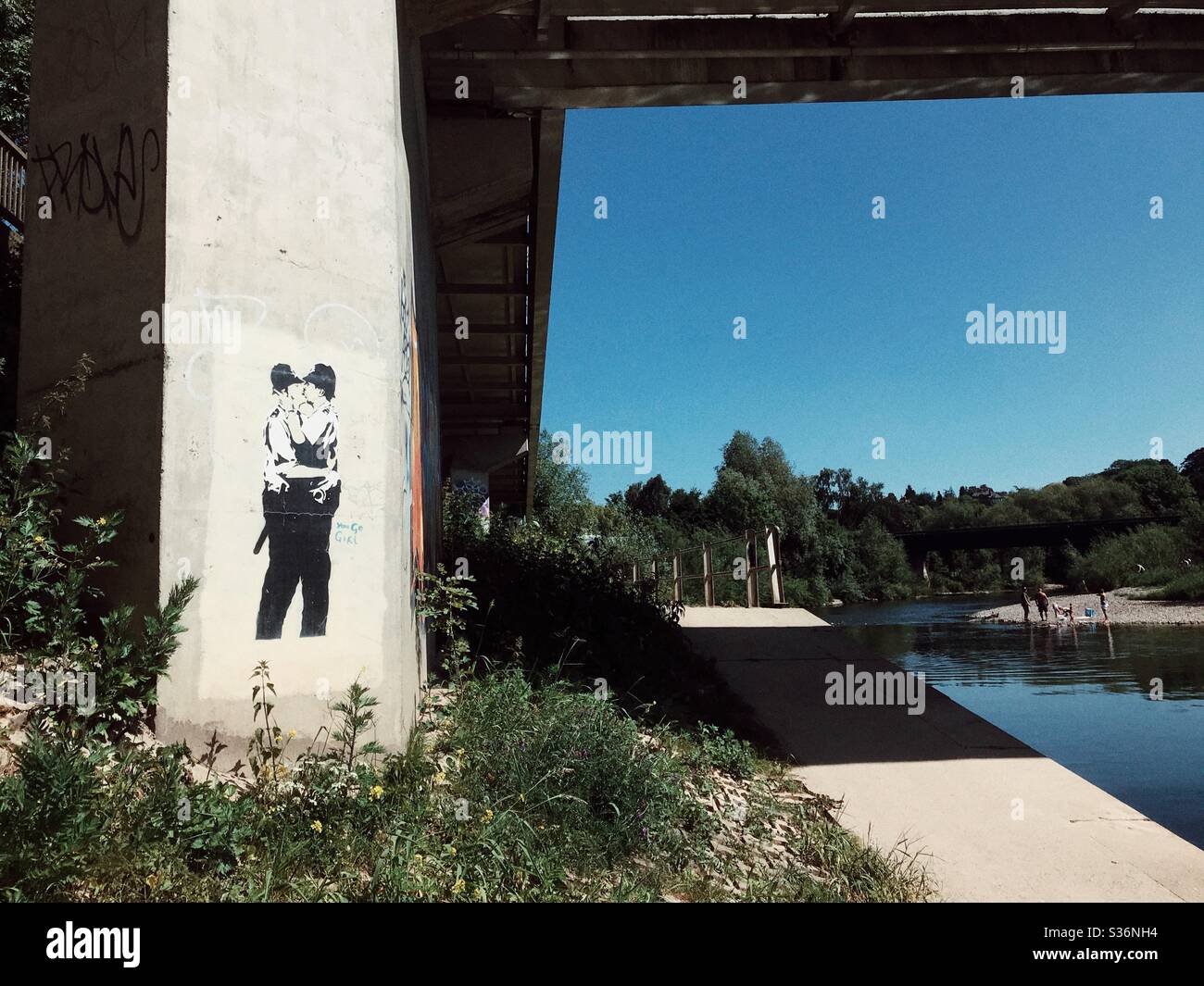 Hereford UK a copy of a famous Banksy artwork of two kissing policemen has appeared as an homage to the artist on a bridge beside the River Wye May 2020 - Smartphone Captured Stock Image