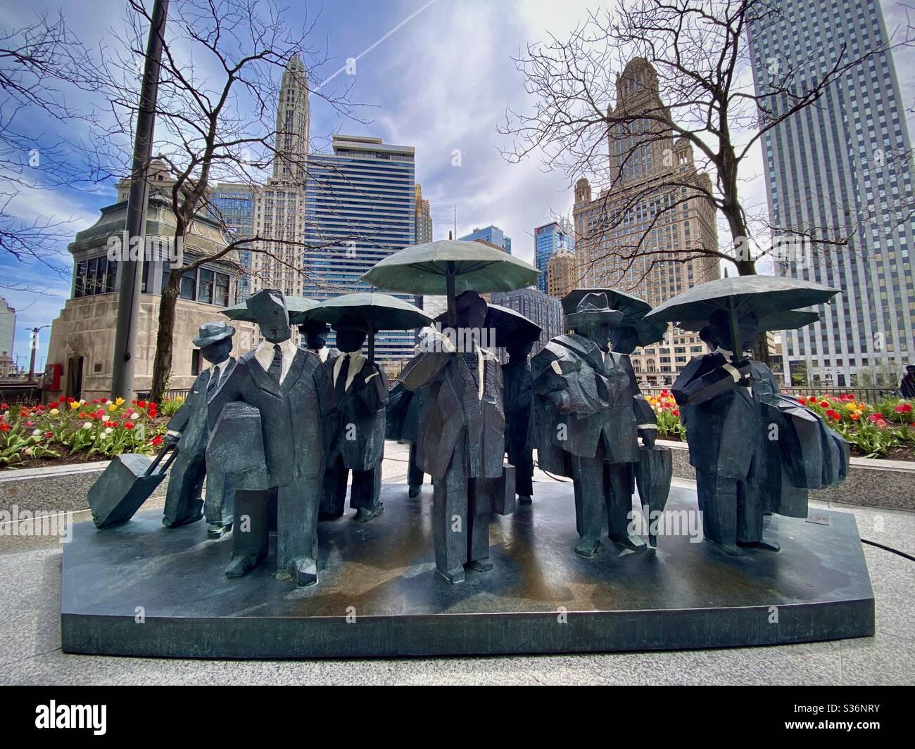 The Gentlemen Statues with downtown buildings in the background