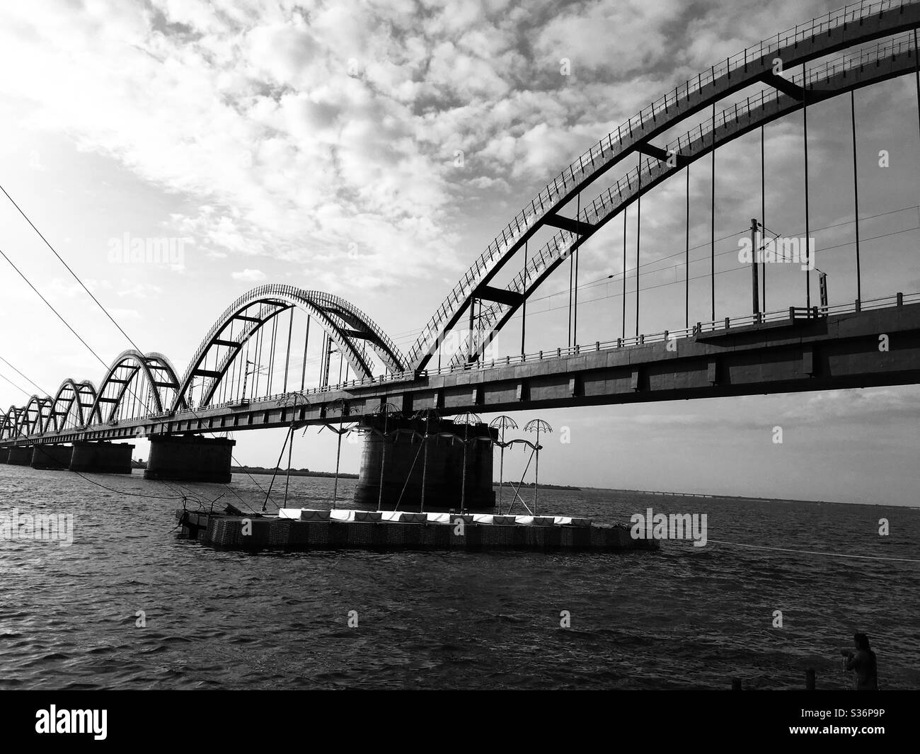Black and white view of bridge on the banks of Godavari river near Rajahmundry, India. Stock Photo