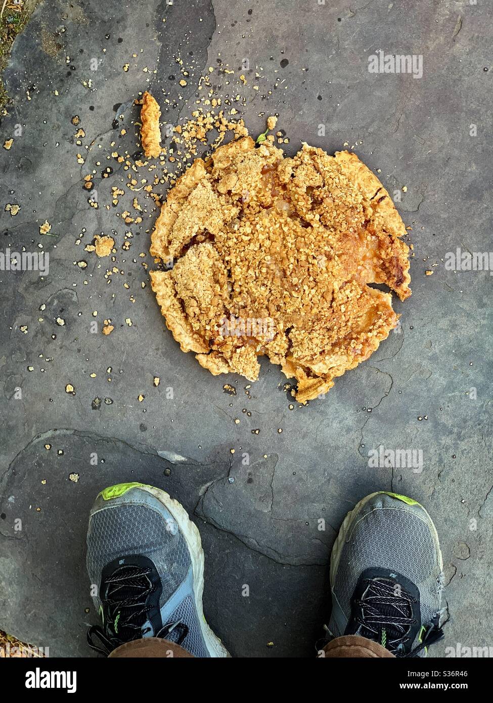 Man drops apple crumble pie on sidewalk  stands there feeling bad  now years of clown college wasted,   juggle class over with ! Stock Photo