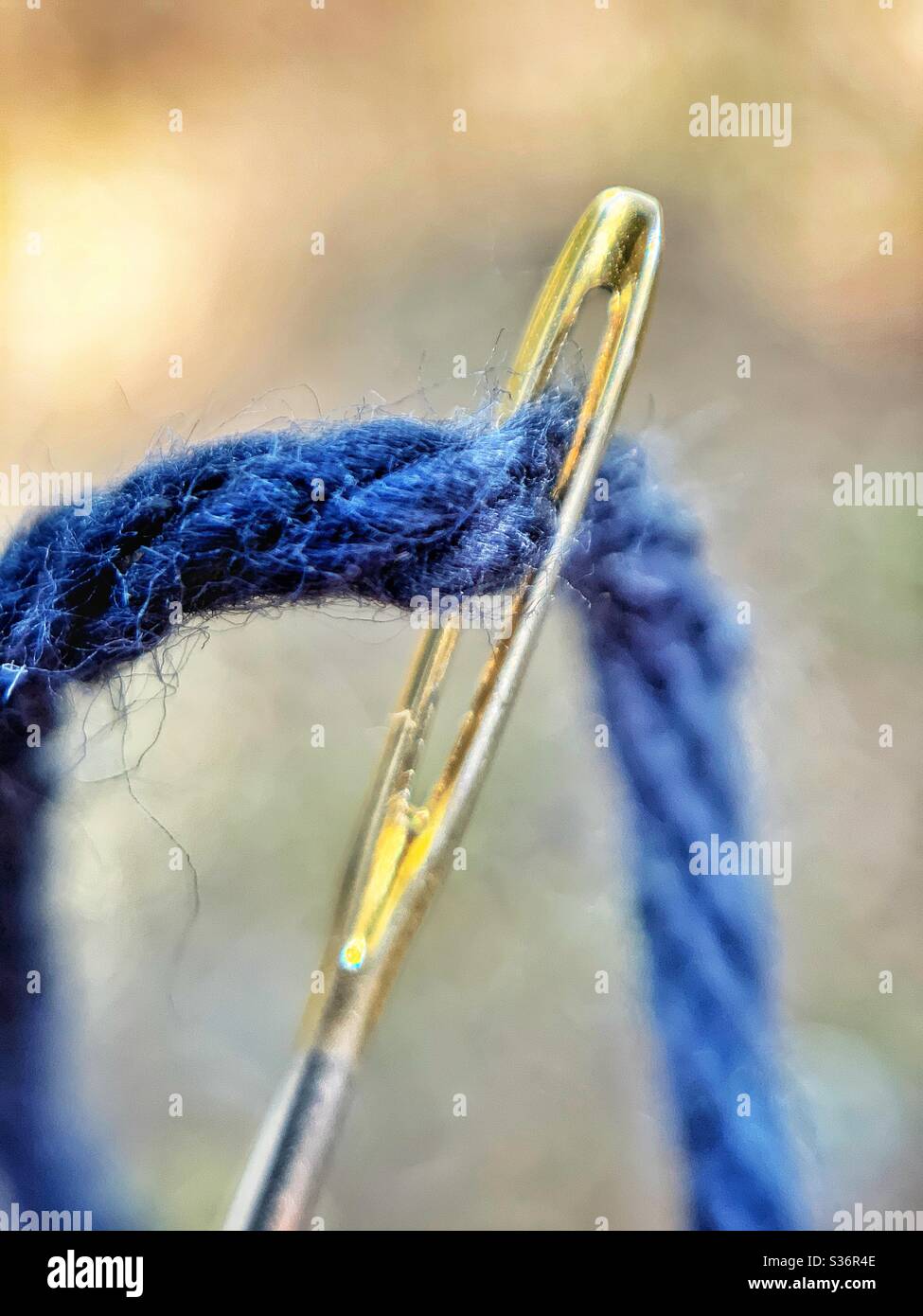 Darning needle threaded with black yarn  close up - Smartphone Captured Stock Image