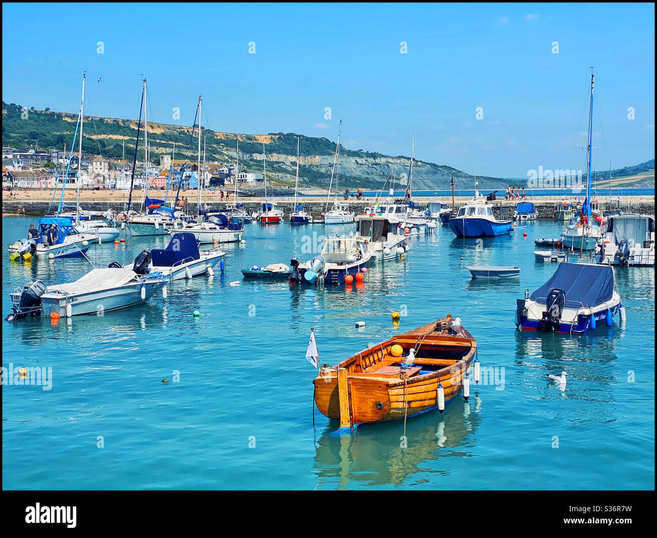 Boats in the harbour at Lyme Regis, Dorset, Southern England. Lyme Regis is on “ The Jurassic Coast” and is a very popular tourist destination. Photo ©️ COLIN HOSKINS. - Smartphone Captured Stock Image