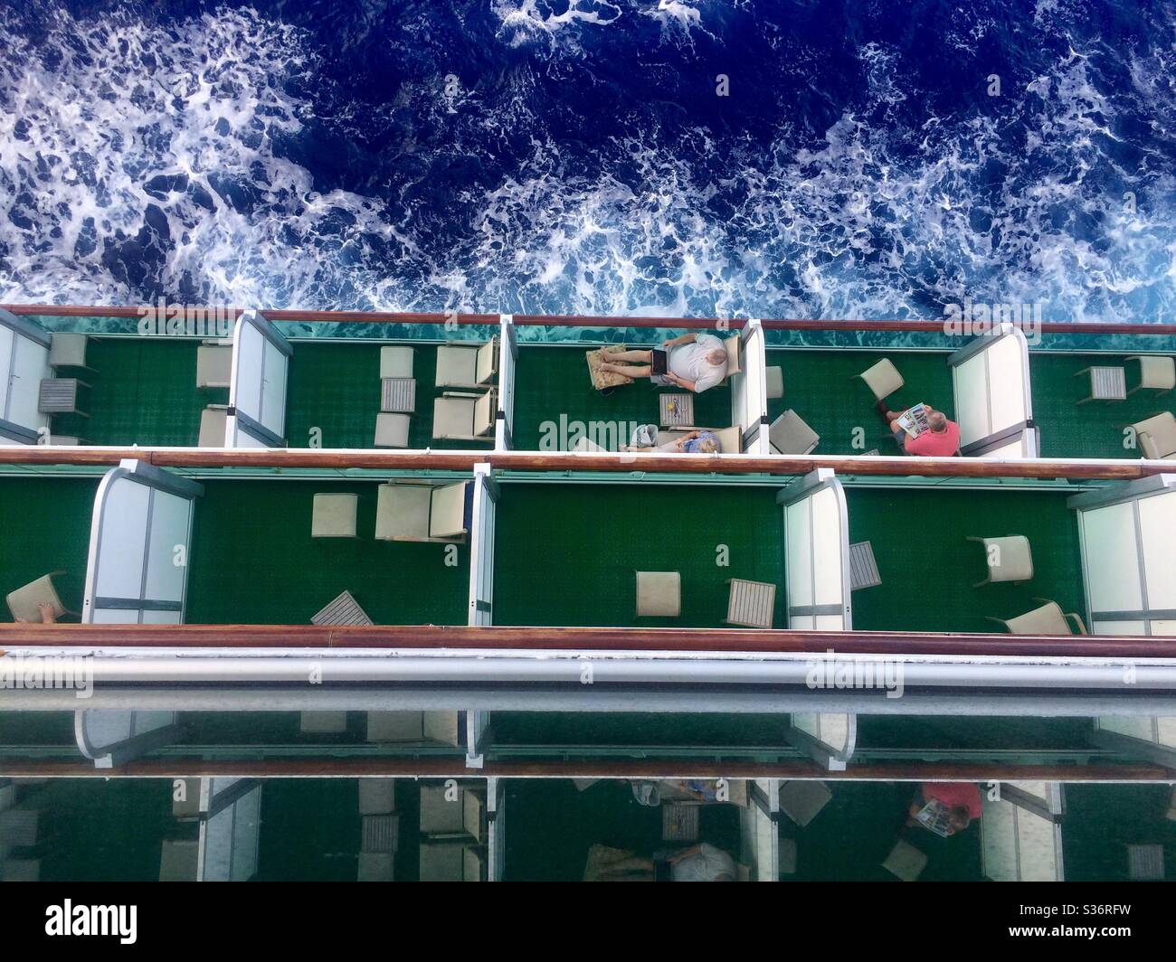 Birds eye view of passengers sitting on their balconies on board cruise ship P&O Ventura as it sails the North Atlantic ocean Stock Photo