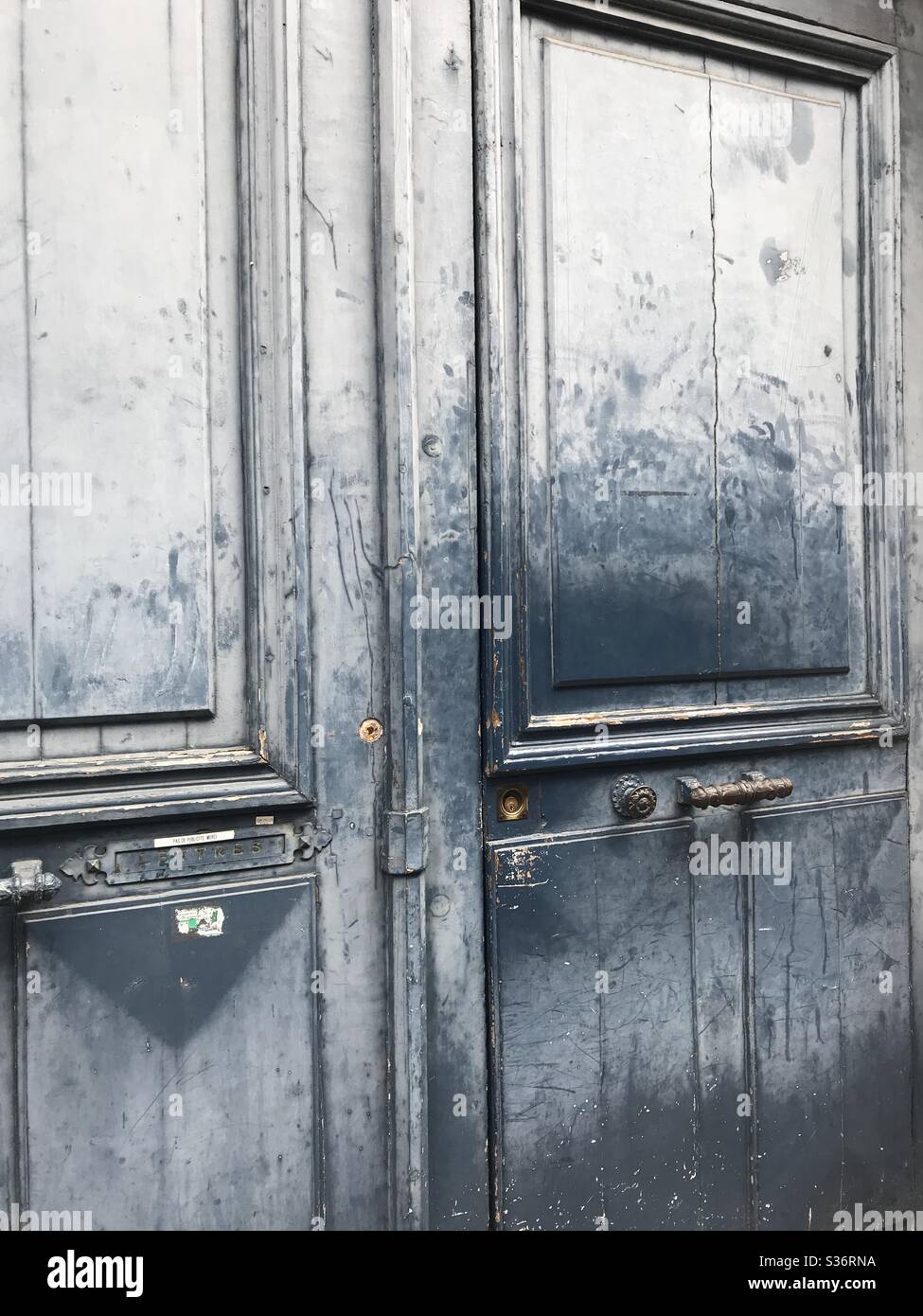 Blue door with ornate door furniture - Smartphone Captured Stock Image