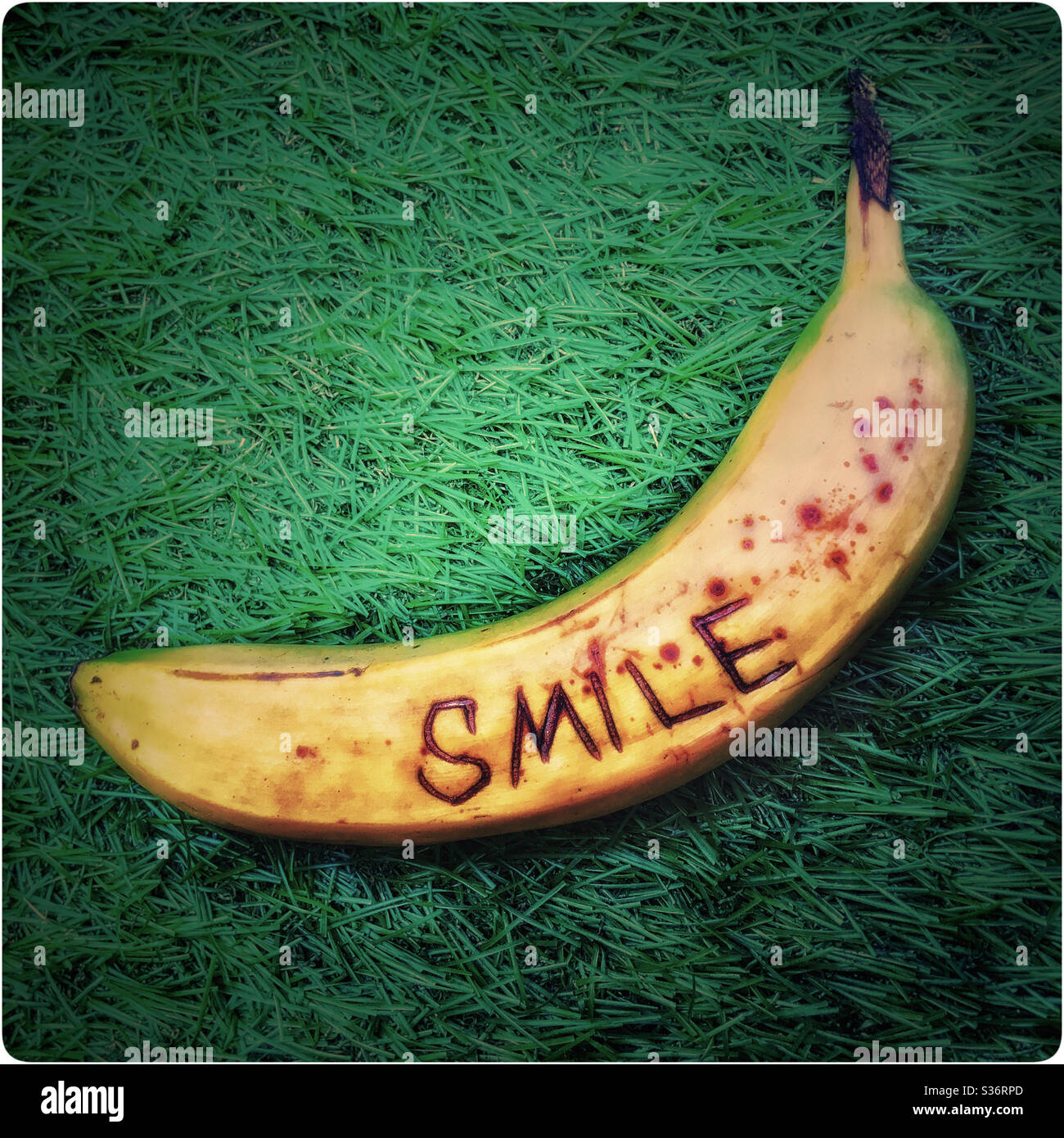 Banana with the word ‘SMILE’ carved into its skin Stock Photo Alamy
