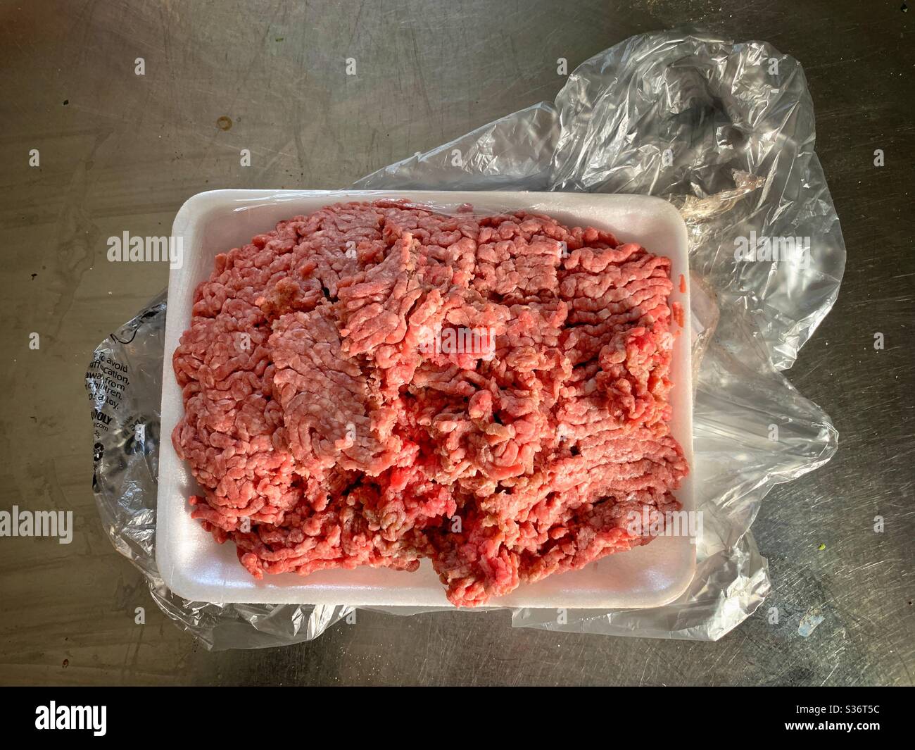 Raw ground beef , hamburger  in plastic  unwrapped Stock Photo