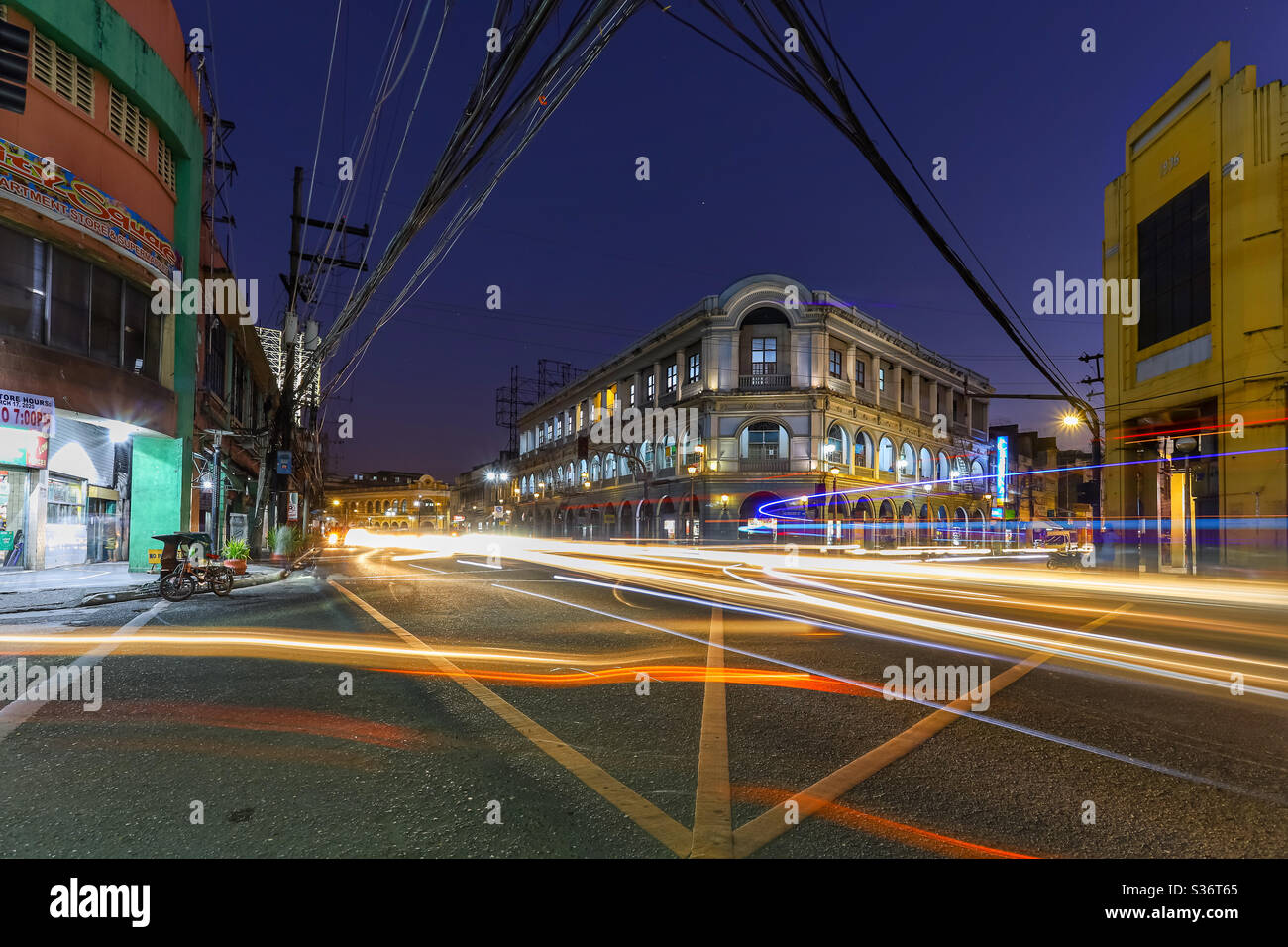Calle Real (Royal Street) or J.M. Basa Street is a historic street in old downtown Iloilo City, Philippines. The street features many neoclassical, beaux-arts, and Art Deco buildings. Long exposure Stock Photo