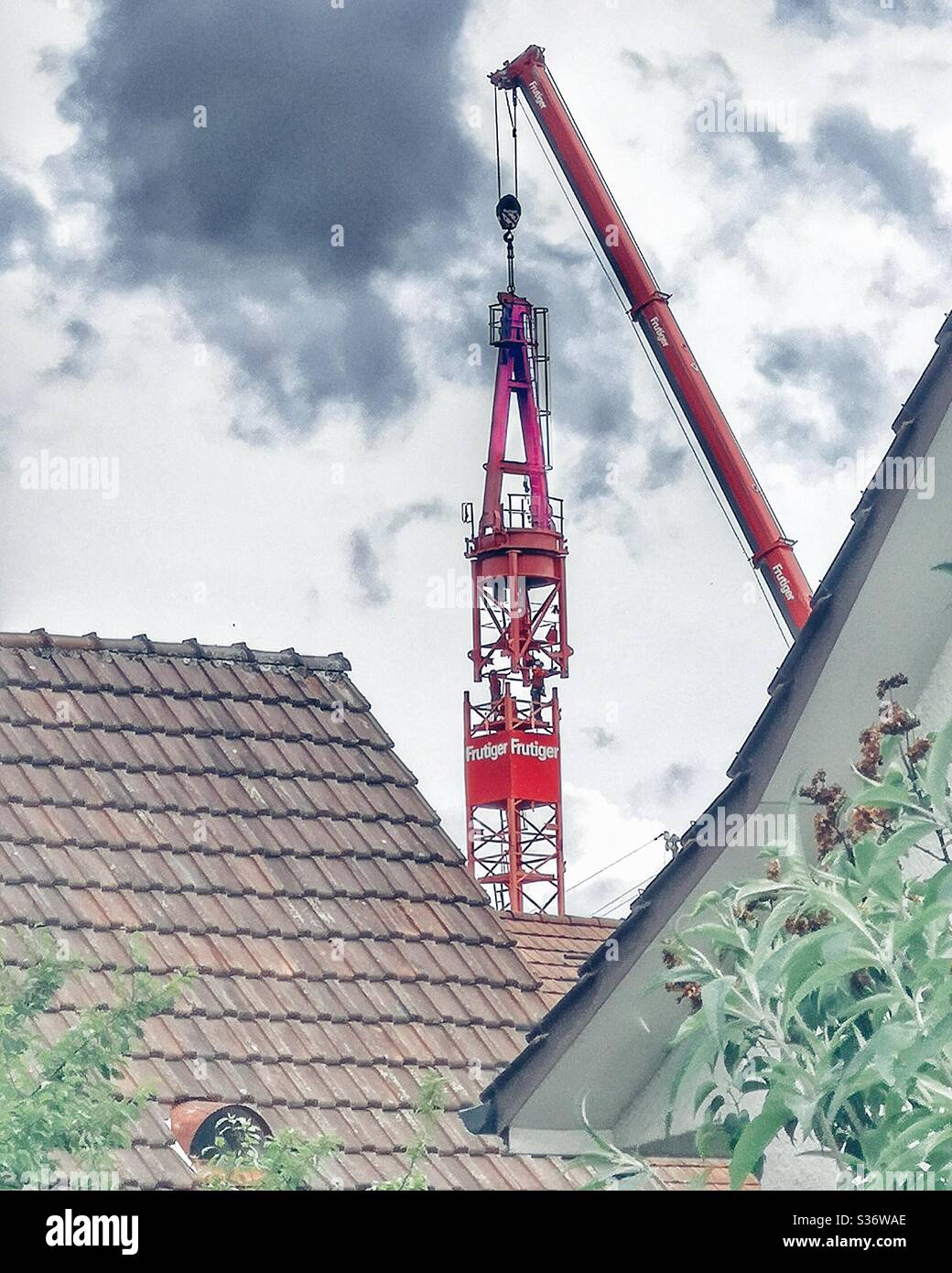 Erecting a red crane - Smartphone Captured Stock Image