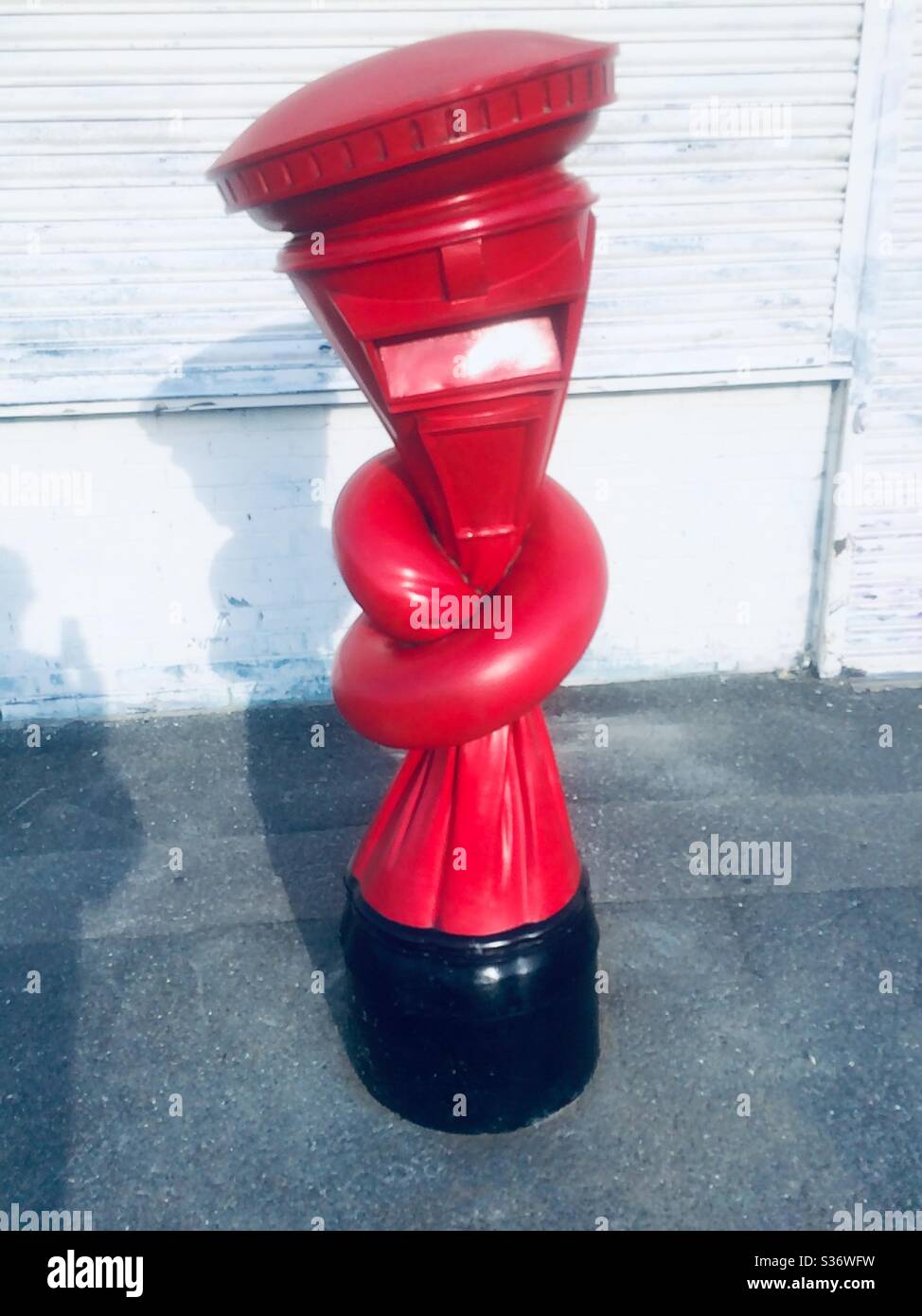 Street art knotted red letter box by artist Alex Chinneck in Margate for the Turner Prize Stock Photo