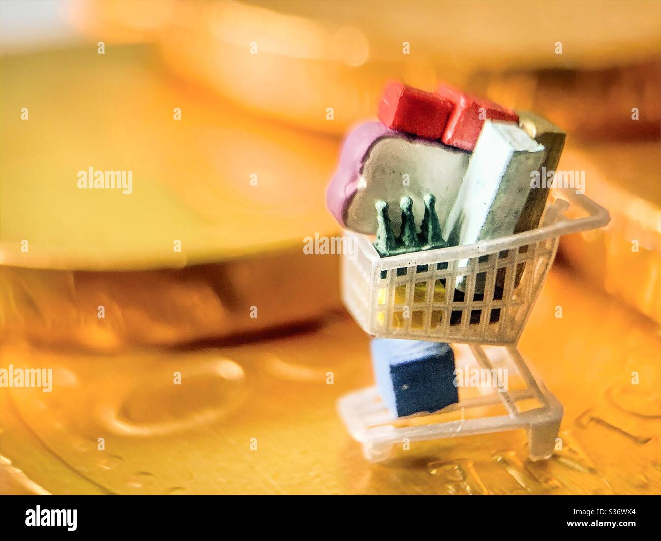 Price of shopping.  Shopping trolley or cart on money coin.  Inflation, taxes, and post-covid 19 coronavirus cost of living.  Interest rates - Smartphone Captured Stock Image