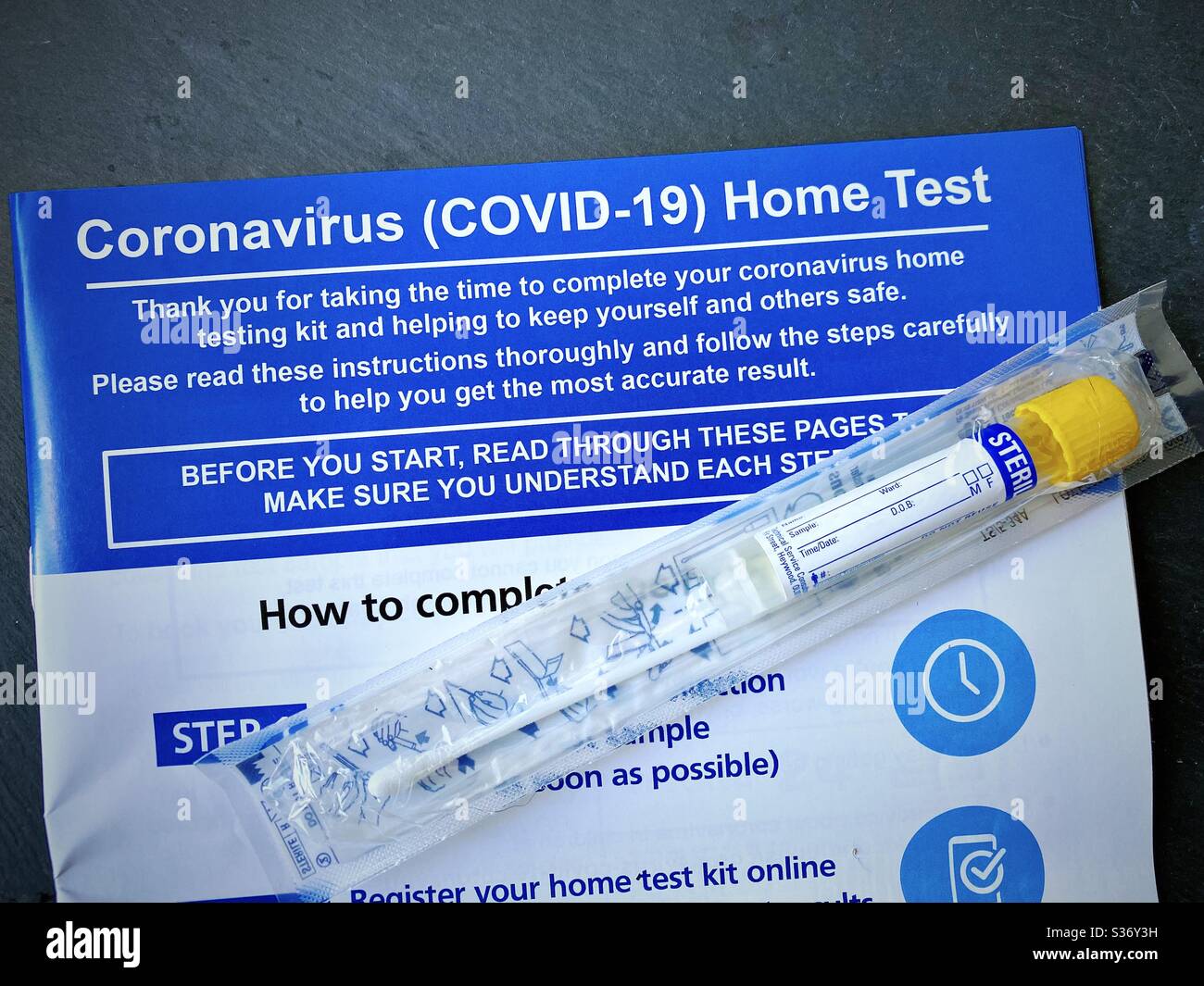 DURHAM, ENGLAND, UK - JUNE 2020: Close up view of a Coronavirus Covid-19 Home Test Kit delivered by courier to symptomatic patient with instructions and sterile swab - Smartphone Captured Stock Image