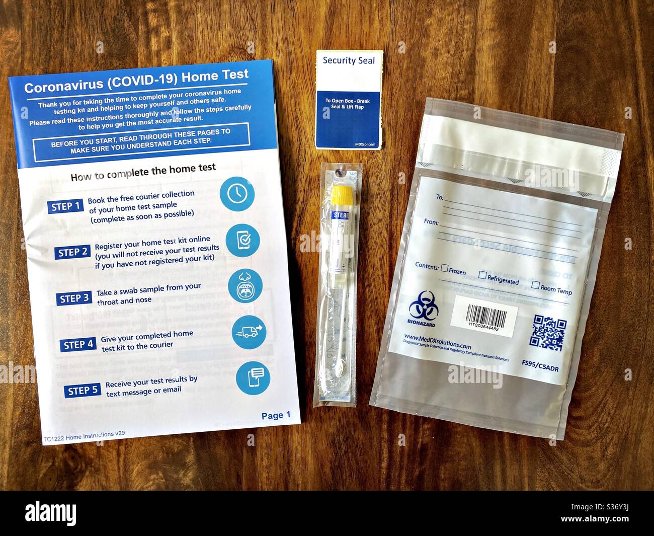 DURHAM, ENGLAND, UK - JUNE 2020: Close up view of a Coronavirus Covid-19 Home Test Kit delivered by courier to symptomatic patient with instructions and sterile swab - Smartphone Captured Stock Image