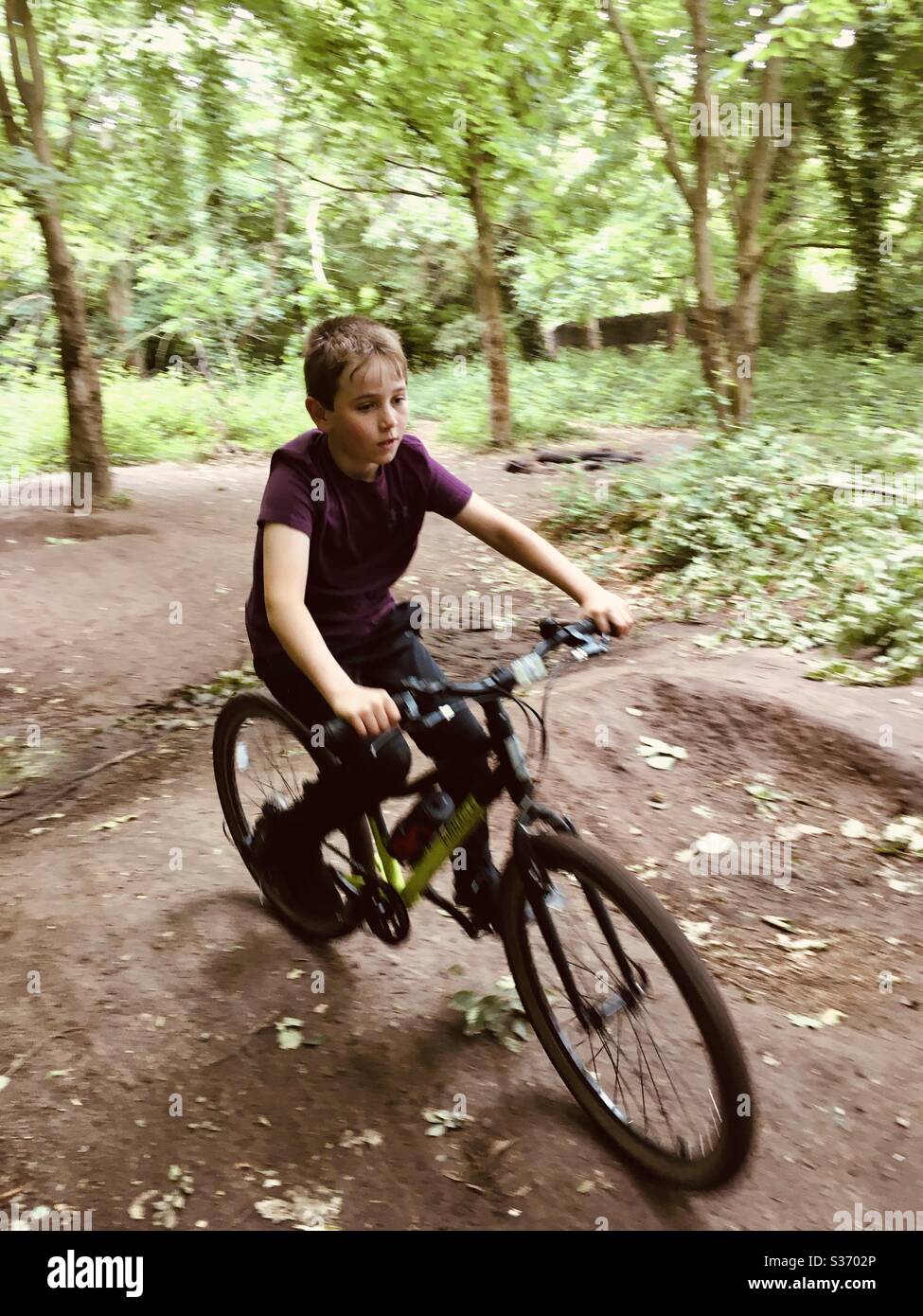 Boy riding a bicycle over bumps - Smartphone Captured Stock Image