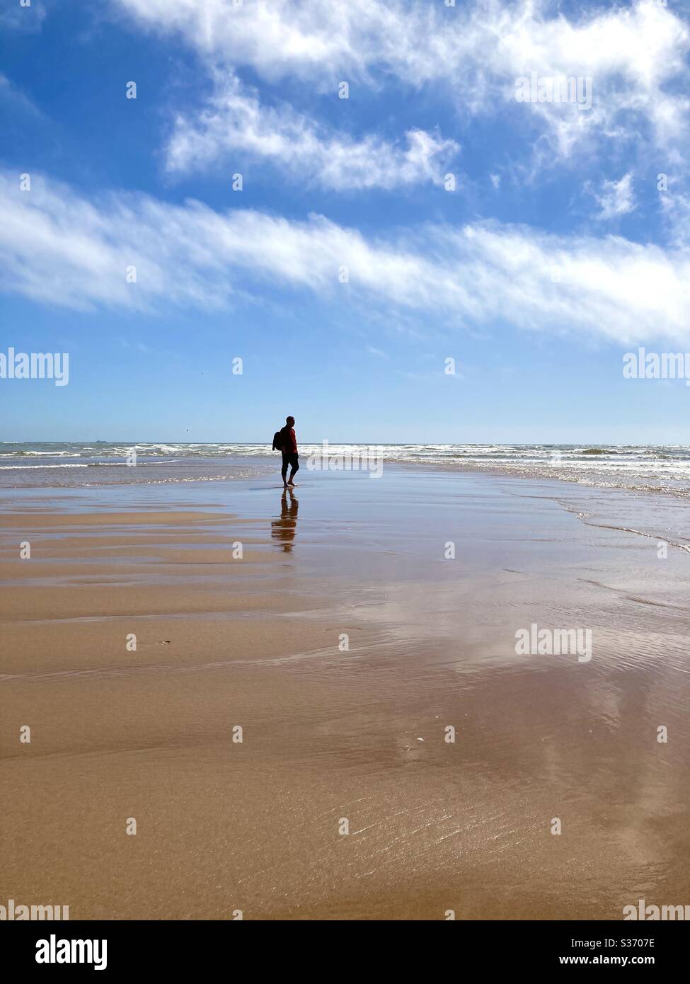 Lonely man at beach hi-res stock photography and images - Alamy