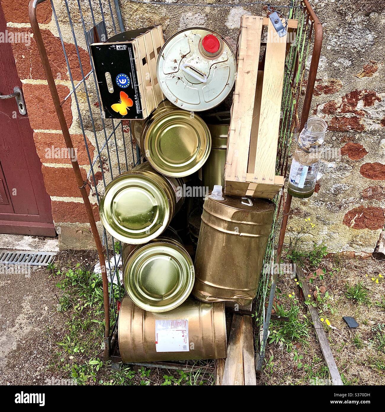 Empty cooking oil tins outside restaurant kitchen door. - Smartphone Captured Stock Image