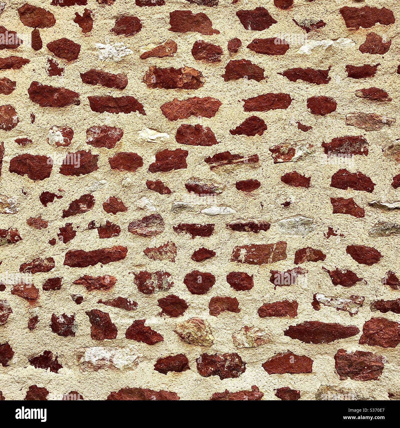 Random stone wall showing iron content in local stone, Brenne, Indre, France. - Smartphone Captured Stock Image