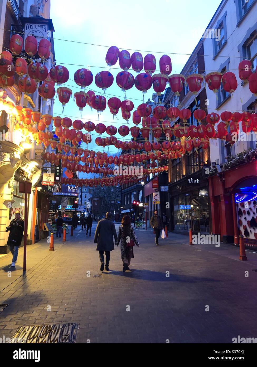 Couple holding hands in Chinatown London 19th March 2020 just before Lockdown - Smartphone Captured Stock Image