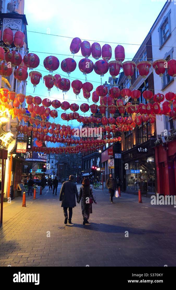 Couple holding hands, Chinatown London March 2020 Year of the Rat - Smartphone Captured Stock Image