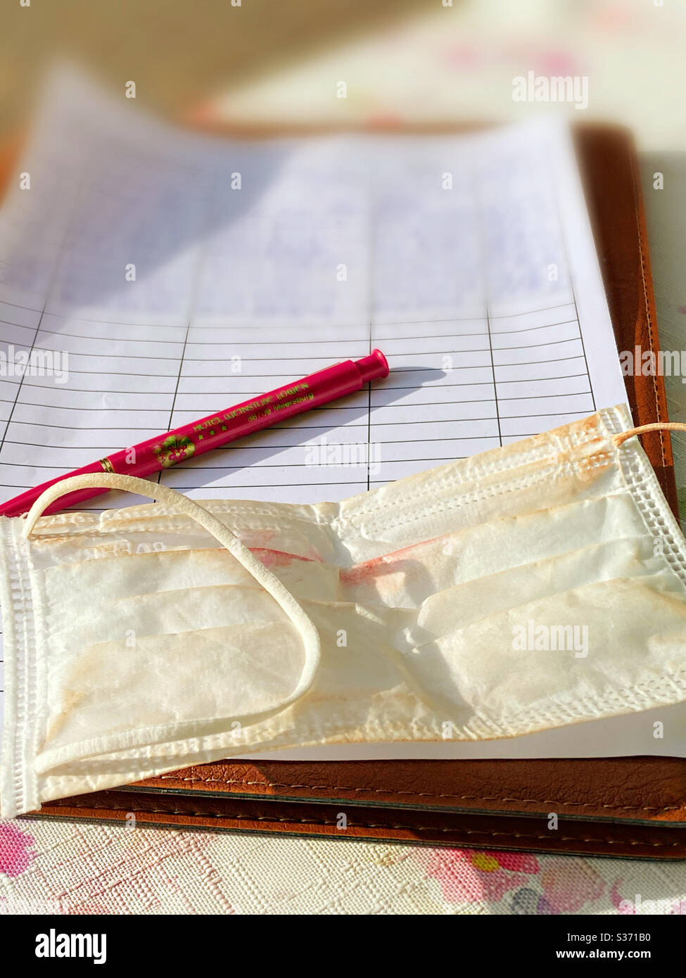 The list with data and protective mask... - Smartphone Captured Stock Image
