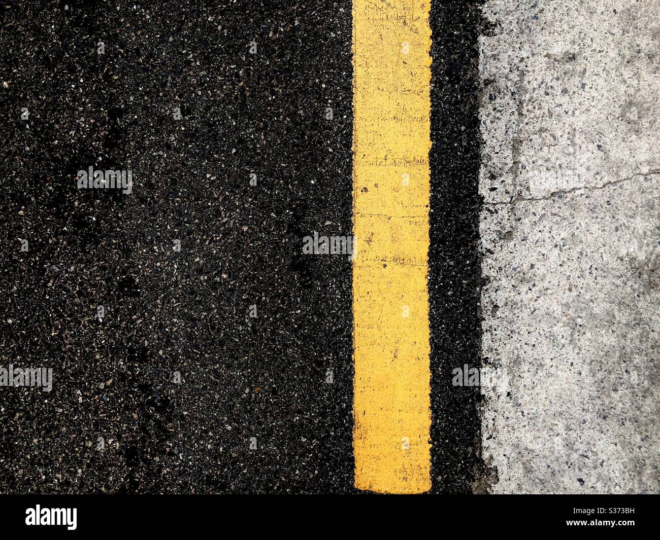 yellow line on asphalt road Stock Photo - Alamy