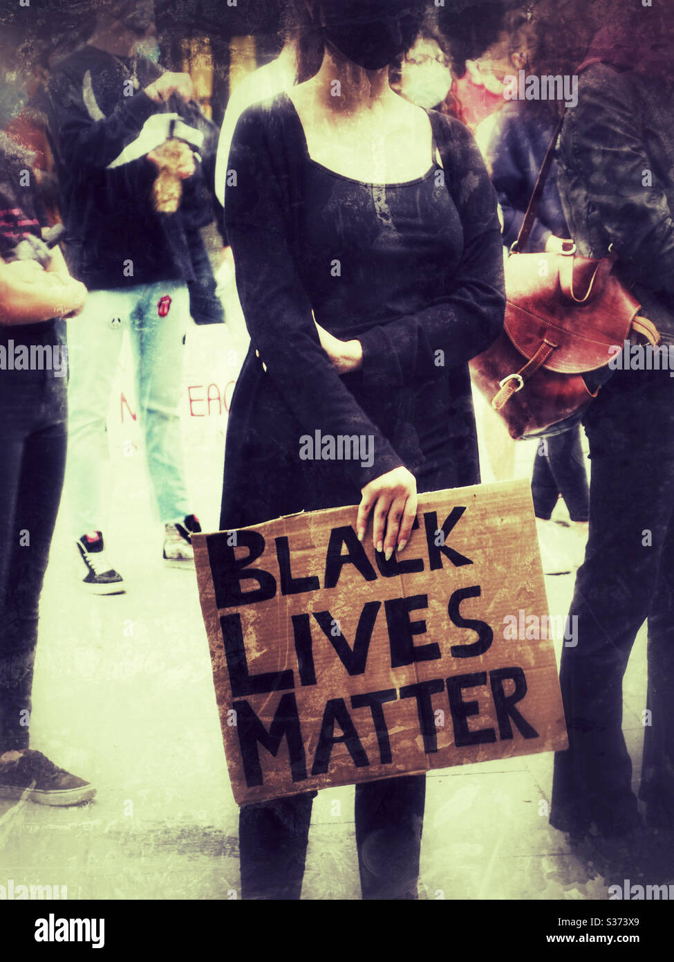 Woman marching against racism with black lives matter sign Stock Photo