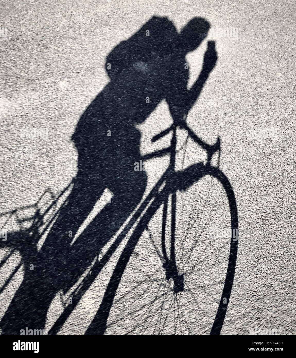 Selfie shadow taken at speed whilst riding a bicycle. - Smartphone Captured Stock Image