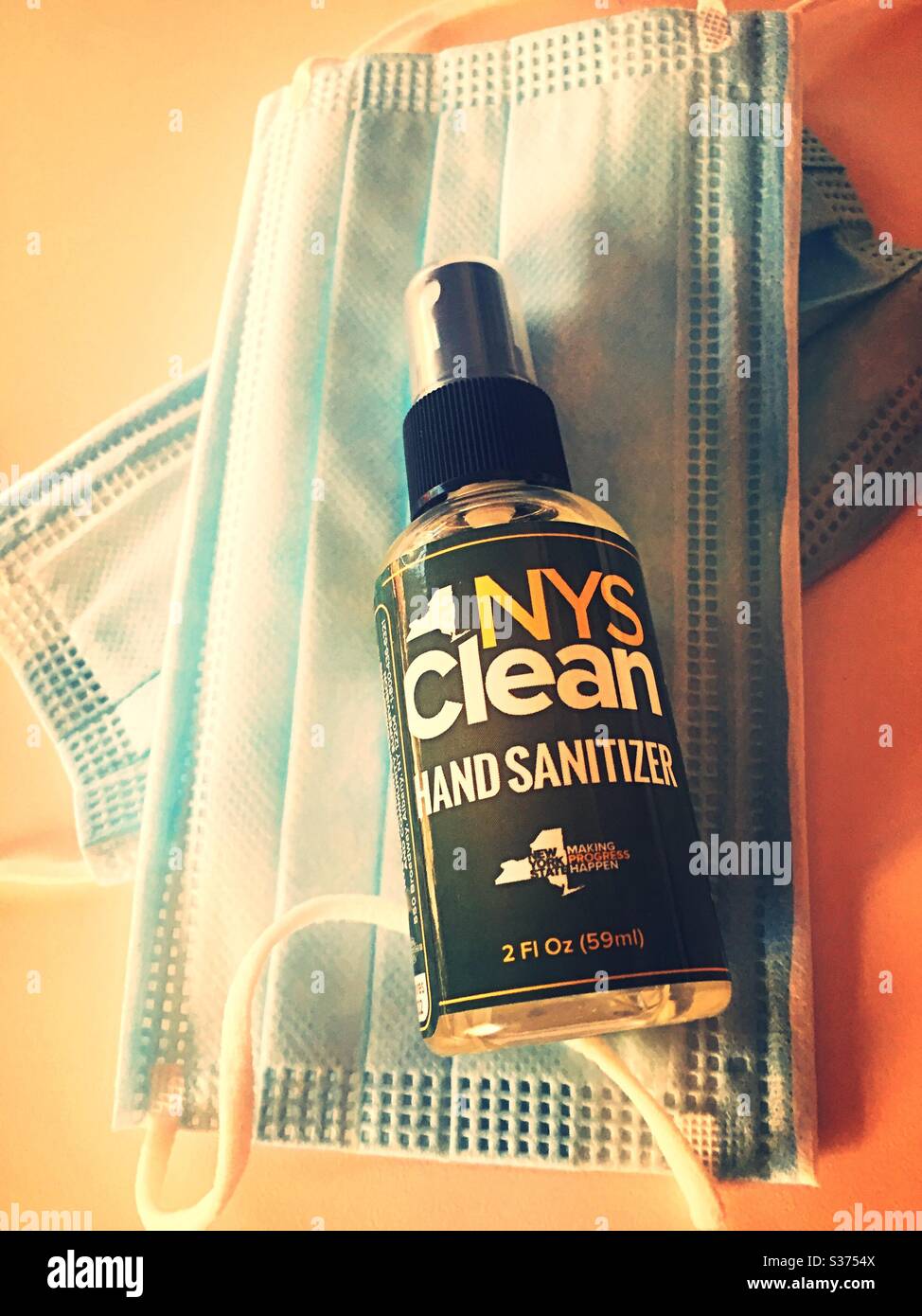 Hand sanitizer Spray bottles and facemasks are being given away for free to the public by New York state representatives during the coronavirus pandemic, 2020, New York State, USA - Smartphone Captured Stock Image