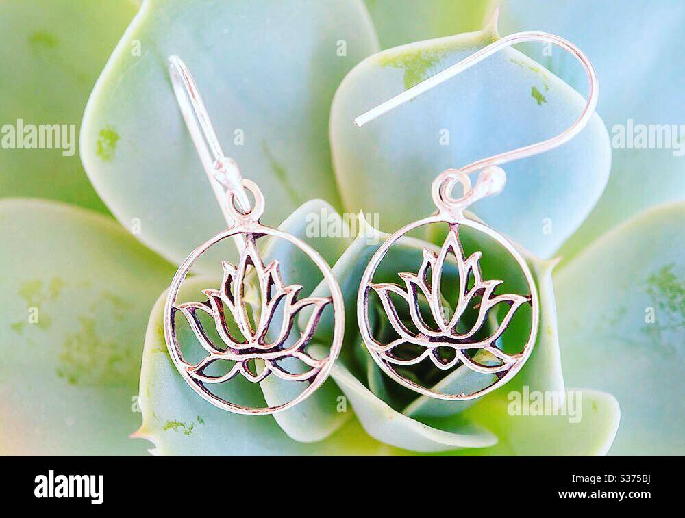 Silver earrings in the shape of lotus Stock Photo