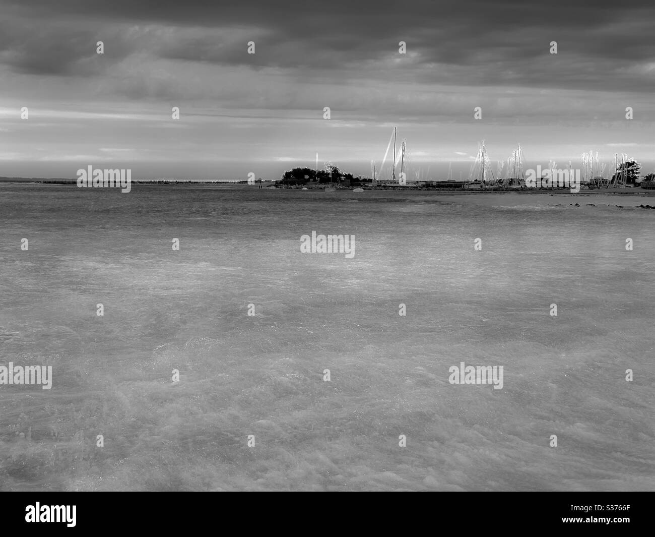 Black and white long exposure of sea waves under dramatic sky - Smartphone Captured Stock Image